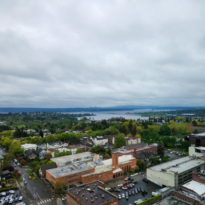 An aerial view of a city with a lake in the background